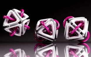 three pink-and-white glass accessories