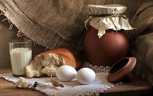 two white eggs near bread