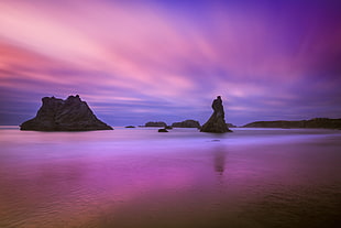rock formation surrounded with body of water under blue and pink sky, oregon HD wallpaper