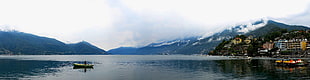 panoramic photo of person riding on boat, lago maggiore
