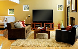 rectangular brown wooden coffee table with flat screen TV and sofa set