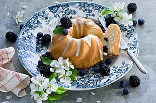 brown and white doughnut with white and blue floral plate