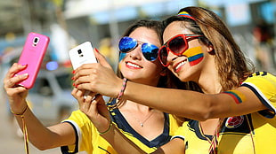 two women taking selfie with painted faces HD wallpaper
