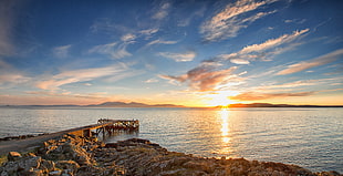 brown wooden dock over viewing wide ocean at sunset HD wallpaper