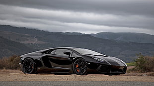 black sports coupe under gray sky HD wallpaper