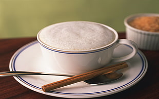 white ceramic tea cup and saucer set with spoon