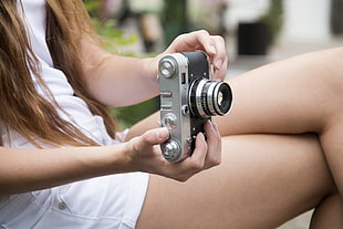 woman wearing silver and black camera