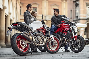 two man wearing black leather jacket with red and white Ducati XDiavel motorcycles