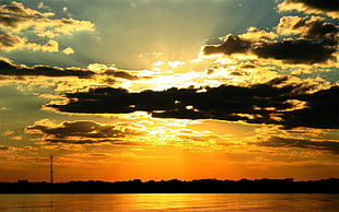 photography of silhouette of clouds and sun