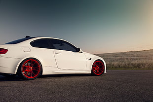 white coupe parked on asphalt road near grass during daytime HD wallpaper
