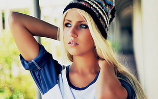 woman in blue and white raglan shirt with white and black knitted hat