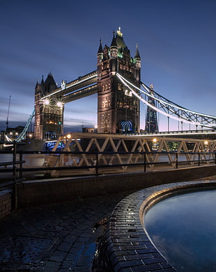 london tower bridge near body of water during night time