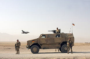 soldiers standing near military vehicle