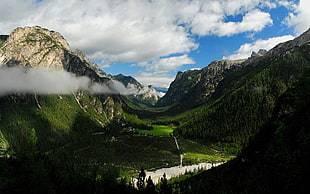 photography of green mountains under white and blue cloudy sky