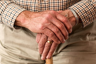 person wearing of gold band ring
