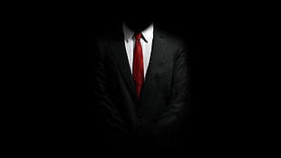 man wearing black suit and red necktie