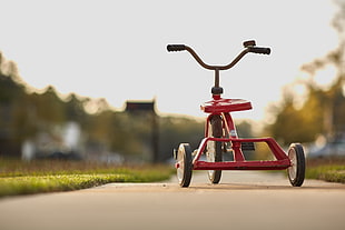 shallow focus photography of red pocket trike during daytime