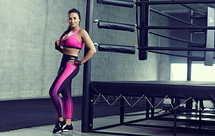 woman wearing yoga pants and sports bra near boxing ring