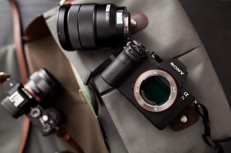 black and gray Sony Ol 7s on gray textile HD wallpaper