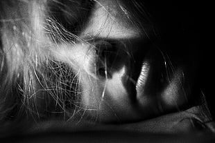 too close photo of woman's face on grayscale photography