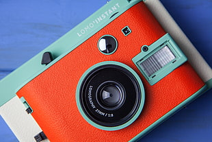 red and teal point-and-shoot camera