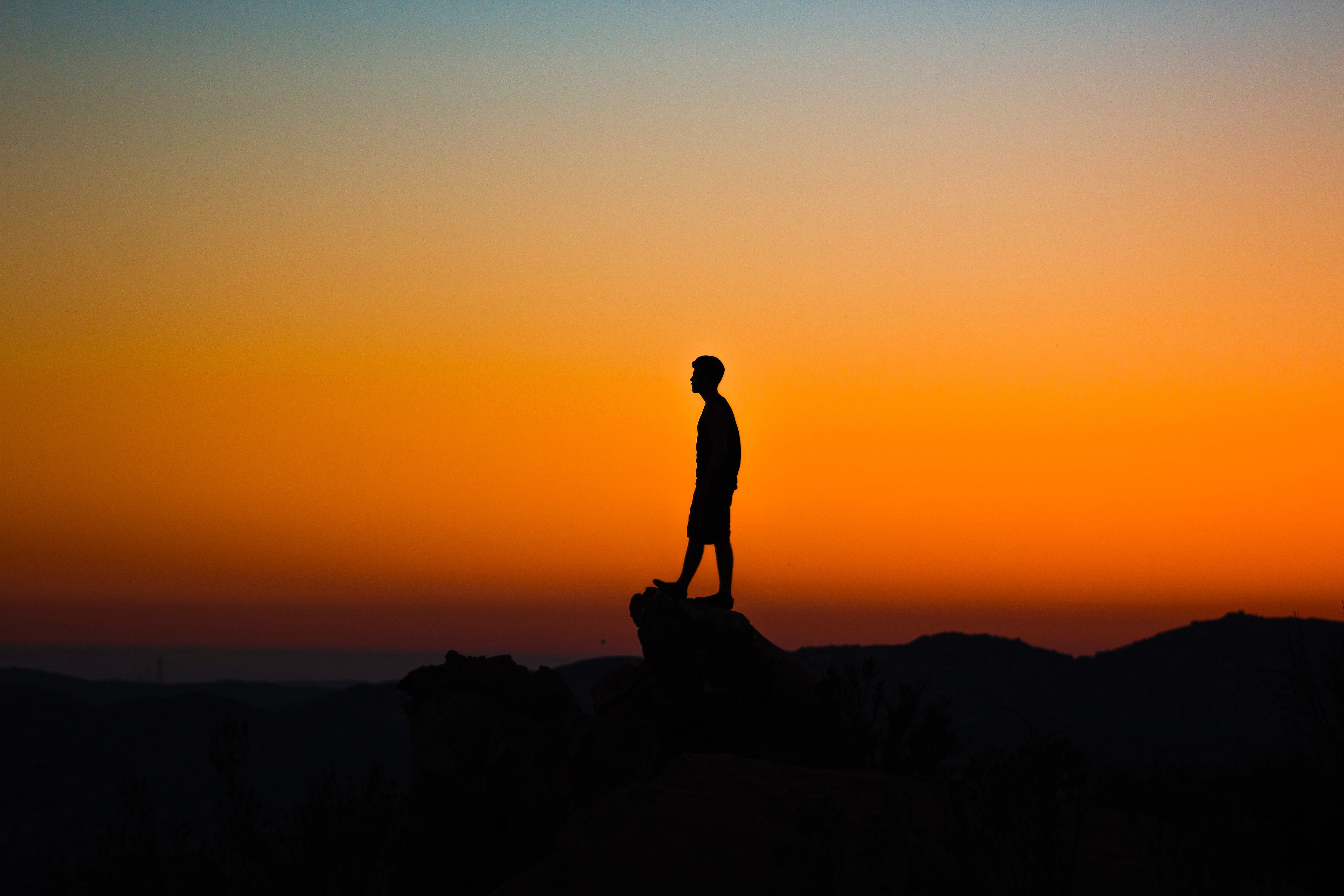 Silhouette Of Man On Top Of Rock Formation HD Wallpaper Wallpaper