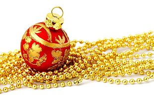 closeup photo of red and gold-colored baubles