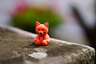 red plastic cat figure