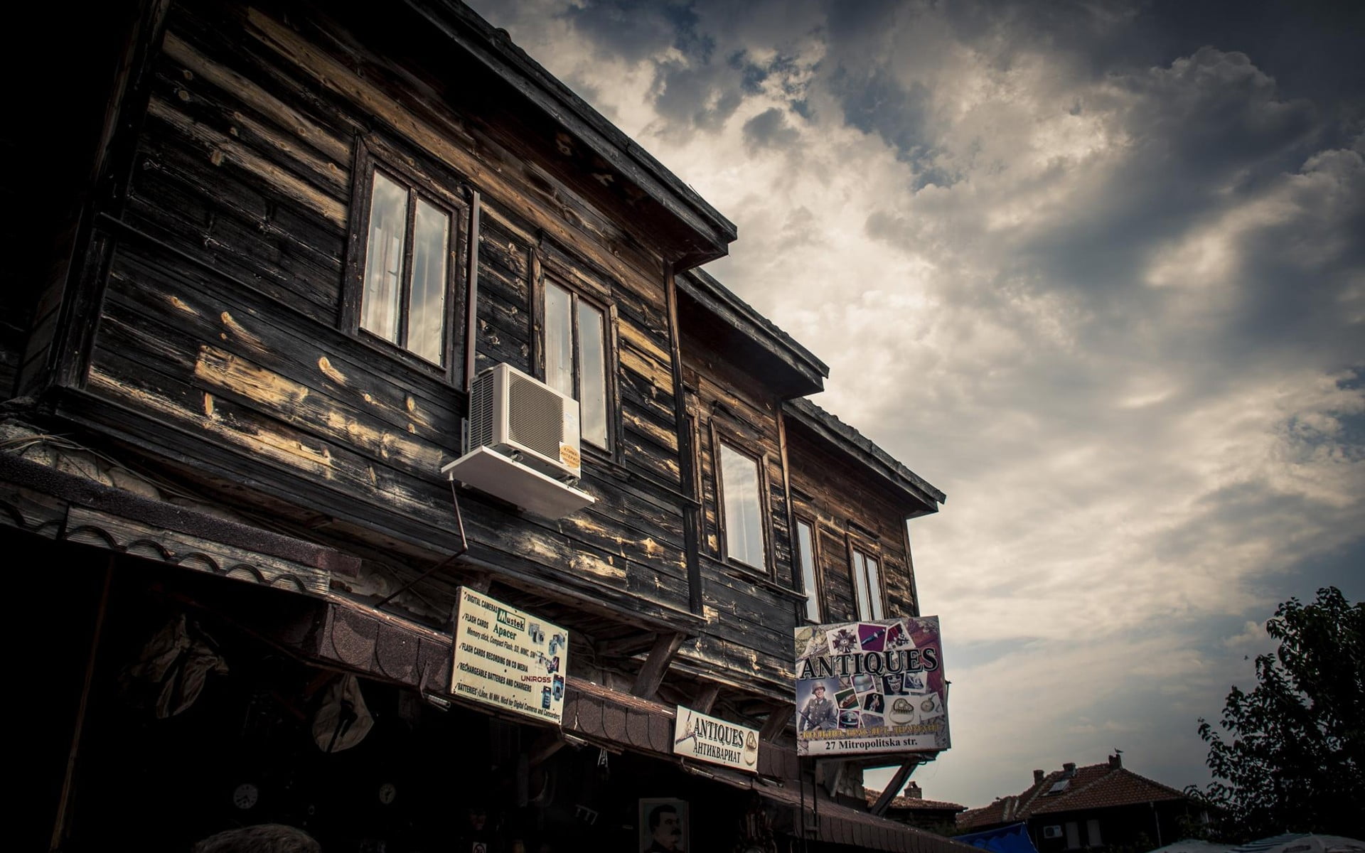 low angle photography of house with Antique store facade and air condenser