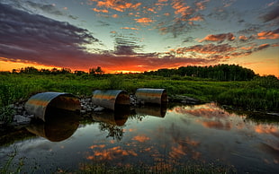 three round silver pipes, nature, sunset, water, clouds HD wallpaper