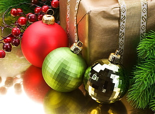 three gray, green, and red Christmas baubles