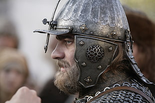 person wearing gray iron helmet