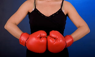 woman wearing black camisole with red boxing gloves