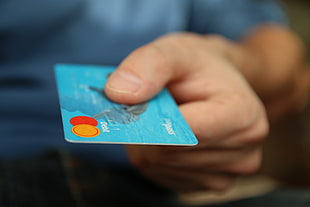 blue labeled magnetic strip card in human hand