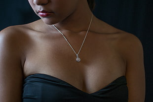 woman wearing blue strapless sweetheart neckline dress and silver necklace