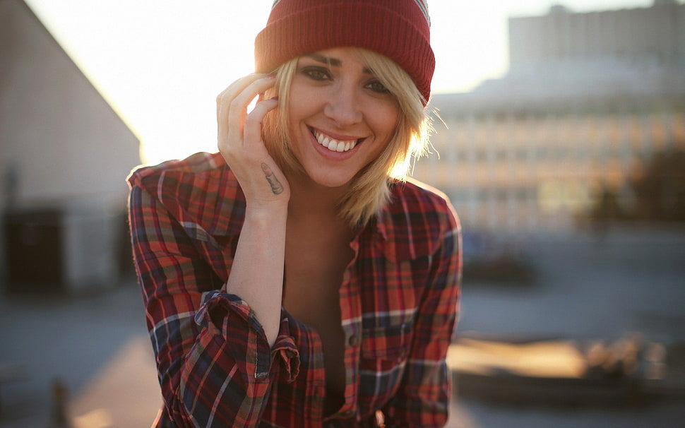 woman in plaid shirt and beanie smiling HD wallpaper