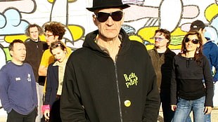 man wearing black hat and zip-up jacket