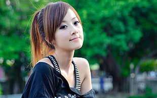 selective focus photo of woman wearing black off-shoulder top
