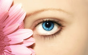 woman eye beside pink flower