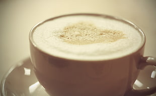 closeup photo of cappuccino on brown ceramic cup