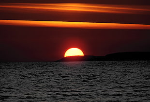 sun setting over horizon HD wallpaper