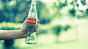 clear Coca-Cola glass bottle, Coca-Cola, bottles, hands