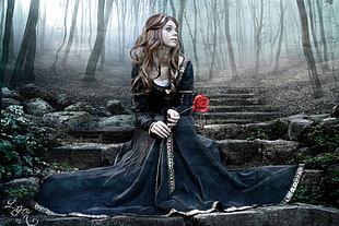 woman in black dress holding white Rose photo