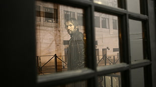 black frame window overlooking man wearing black leather jacket