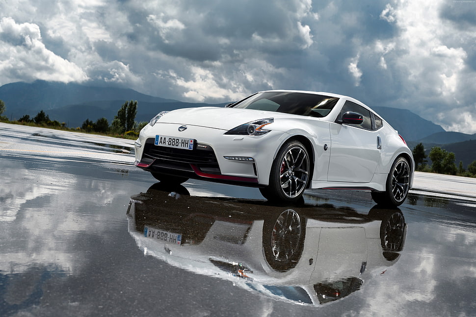 white Nissan coupe on wet road during daytime HD wallpaper