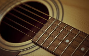 close up photo of brown guitar