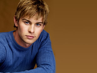 blonde haired man wearing blue sweater