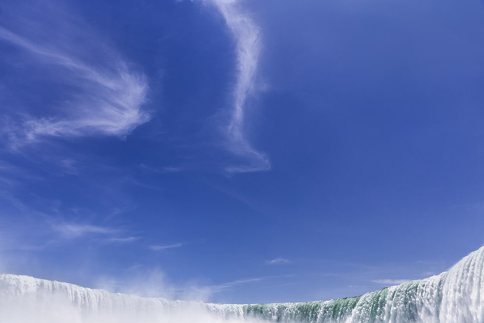 waterfalls caption under clear blue skies HD wallpaper