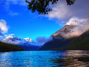 mountain with body of water during daytime, lake gunn