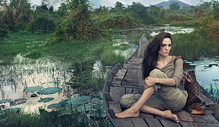 gray dressed woman on gray boat